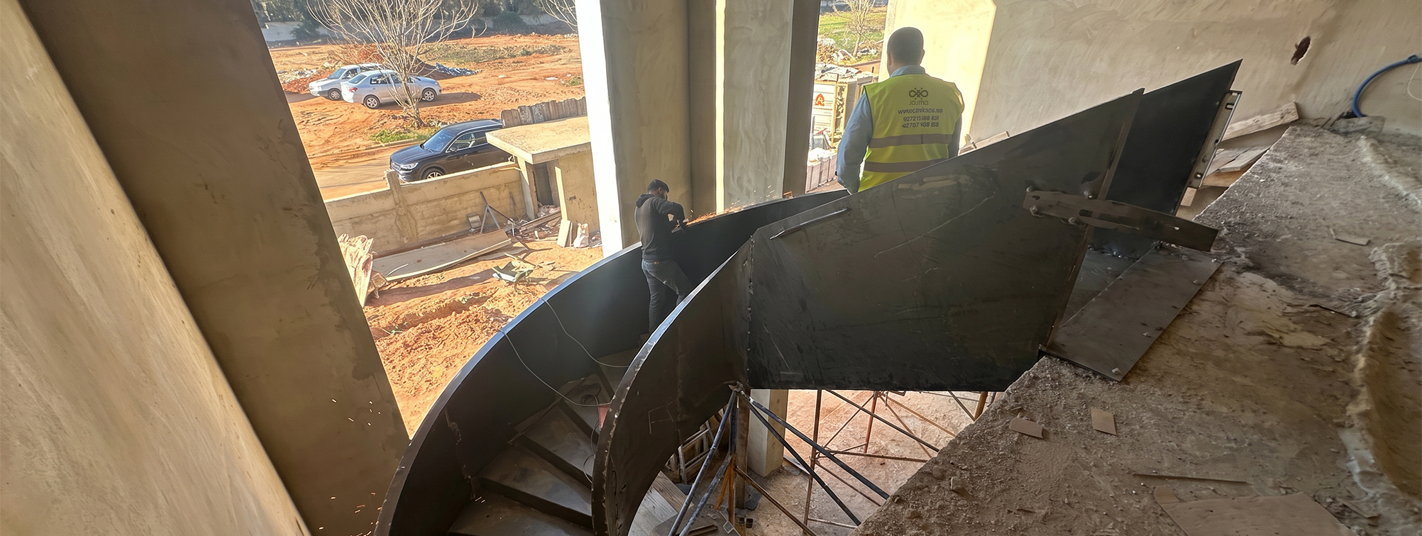 Installation sur chantier d’un escalier métallique hélicoïdal sur mesure par une équipe spécialisée