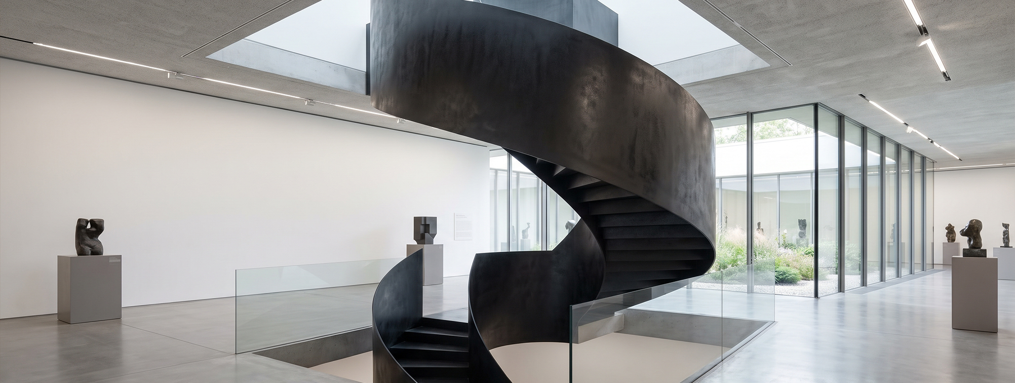 Escalier hélicoïdal métallique sur mesure à géométrie sculpturale dans un espace architectural contemporain